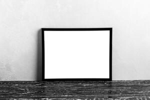 Wooden floor over concrete or decorative plaster wall and black photo frame with copy space for a text background. Mock up.