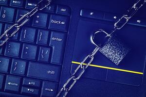 Black keyword and metal chain with lock. The concept of blocking or ban electronic money, e-business, mining, gaming or internet. Computer security or data protection. photo