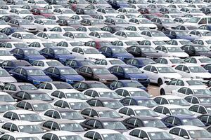 Rows of a new cars parked in a distribution center of a car factory. Top view to the parking in the open air. photo