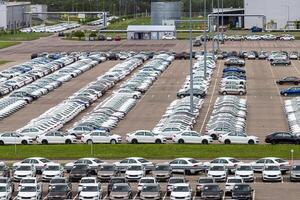 Volkswagen Group Rus, Russia, Kaluga - MAY 24, 2020 Rows of a new cars parked in a distribution center on a cloudy day in the spring, a car factory. Parking in the open air. photo
