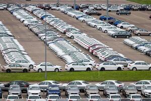 Volkswagen Group Rus, Russia, Kaluga - MAY 24, 2020 Rows of a new cars parked in a distribution center. Top view to the parking in the open air. photo