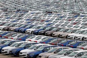 Volkswagen Group Rus, Russia, Kaluga - MAY 24, 2020 Rows of a new cars parked in a distribution center. Top view to the parking in the open air. photo