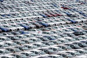 Volkswagen Group Rus, Russia, Kaluga - MAY 24, 2020 Rows of a new cars parked in a distribution center on a cloudy day in the spring, a car factory. Parking in the open air. photo