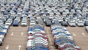 Volkswagen Group Rus, Russia, Kaluga - MAY 24, 2020 Rows of a new cars parked in a distribution center on a cloudy day in the spring, a car factory. Parking in the open air. photo