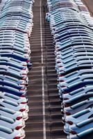 Rows of a new cars parked in a distribution center on a car factory on a sunny day. Parking in the open air. photo