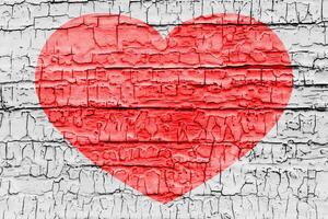 Red heart on a cracked texture. The concept of broken heart and the end of love. photo