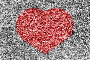 Red heart on a crumpled texture. The concept of broken heart and the end of love. photo