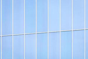 Fragment of an office building with blue mirrored windows. photo