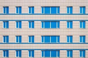 Fragment of an office building with blue mirrored windows. photo