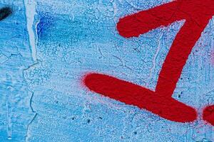 A fragment of colorful graffiti painted on a concrete wall. Abstract urban backdrop for design. photo