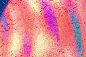 A fragment of colorful graffiti painted on a concrete wall. Abstract urban backdrop for design. photo