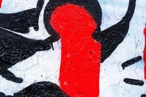A fragment of colorful graffiti painted on a concrete wall. Abstract urban backdrop for design. photo