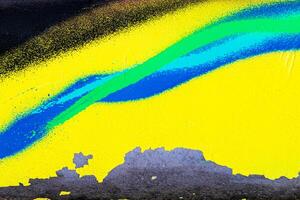 A fragment of colorful graffiti painted on a brick wall. Abstract backdrop for design. photo