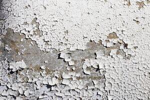 Texture of old white peeling paint on a concrete surface. Abstract backdrop for design. photo