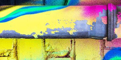 A fragment of colorful graffiti painted on a brick wall. Abstract backdrop for design. photo