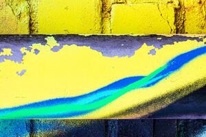 A fragment of colorful graffiti painted on a brick wall. Abstract backdrop for design. photo