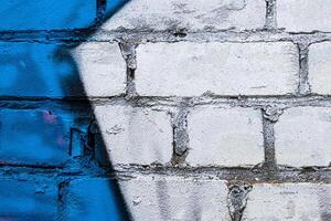 A fragment of colorful graffiti painted on a brick wall. Abstract backdrop for design. photo