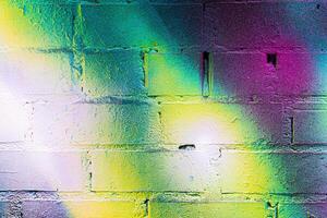 A fragment of colorful graffiti painted on a brick wall. Abstract backdrop for design. photo