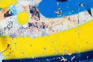 A fragment of colorful graffiti painted on a concrete wall. Abstract urban backdrop for design. photo
