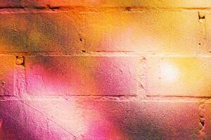 A fragment of colorful graffiti painted on a brick wall. Abstract backdrop for design. photo