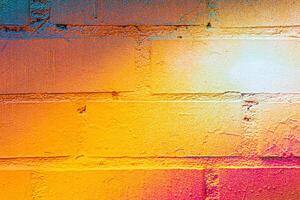 A fragment of colorful graffiti painted on a brick wall. Abstract backdrop for design. photo