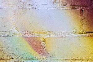 A fragment of colorful graffiti painted on a brick wall. Abstract backdrop for design. photo