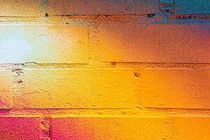 A fragment of colorful graffiti painted on a brick wall. Abstract backdrop for design. photo