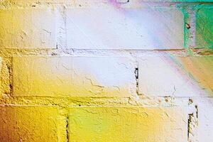 A fragment of colorful graffiti painted on a brick wall. Abstract backdrop for design. photo