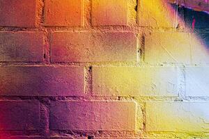 A fragment of colorful graffiti painted on a brick wall. Abstract backdrop for design. photo