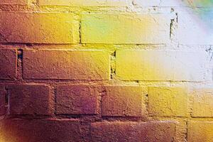 A fragment of colorful graffiti painted on a brick wall. Abstract backdrop for design. photo
