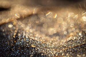 Dew drops on an autumn fallen leaf, shimmering in the sun, shot in close-up with bokeh. Abstract macro backdrop. photo