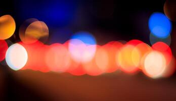 Blurred lights of headlights of cars and lanterns in the night city. Abstract bokeh. photo