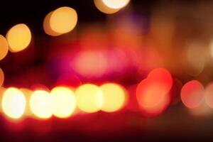 Blurred lights of headlights of cars and lanterns in the night city. Abstract bokeh. photo