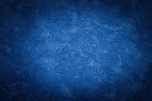 Blue decorative plaster texture with vignette. Abstract grunge background with copy space. photo