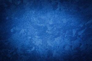 Blue decorative plaster texture with vignette. Abstract grunge background with copy space. photo