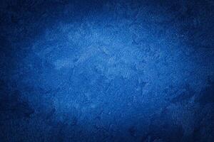 Blue decorative plaster texture with vignette. Abstract grunge background with copy space. photo