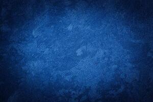 Blue decorative plaster texture with vignette. Abstract grunge background with copy space. photo