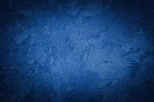 Blue decorative plaster texture with vignette. Abstract grunge background with copy space. photo