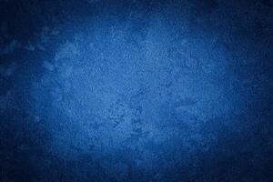 Blue decorative plaster texture with vignette. Abstract grunge background with copy space. photo