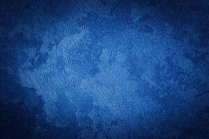 Blue decorative plaster texture with vignette. Abstract grunge background with copy space. photo