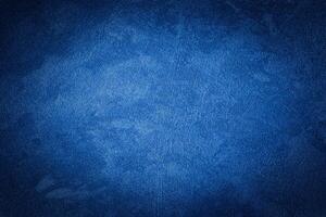 Blue decorative plaster texture with vignette. Abstract grunge background with copy space. photo