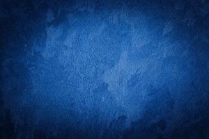 Blue decorative plaster texture with vignette. Abstract grunge background with copy space. photo