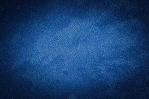 Blue decorative plaster texture with vignette. Abstract grunge background with copy space. photo
