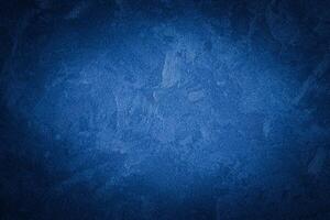 Blue decorative plaster texture with vignette. Abstract grunge background with copy space. photo