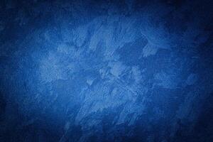 Blue decorative plaster texture with vignette. Abstract grunge background with copy space. photo