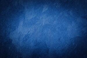 Blue decorative plaster texture with vignette. Abstract grunge background with copy space. photo