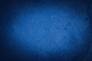 Blue decorative plaster texture with vignette. Abstract grunge background with copy space. photo