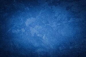 Blue decorative plaster texture with vignette. Abstract grunge background with copy space. photo