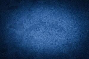 Blue decorative plaster texture with vignette. Abstract grunge background with copy space. photo
