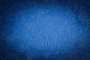 Blue decorative plaster texture with vignette. Abstract grunge background with copy space. photo